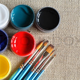 1738935-250803-set-of-paintbrushes-and-color-paint-on-canvas-background-jpg