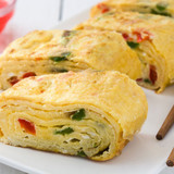 Traditional-tamagoyaki-japanese-omelette-white-wooden-table-close-up_123827-4951