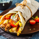 Gyros-souvlaki-wraps-pita-bread-with-chicken-potatoes-tzatziki-sauce_79830-1784